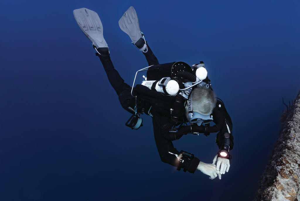 diver using garmin descent™ x50i dive computer under the water