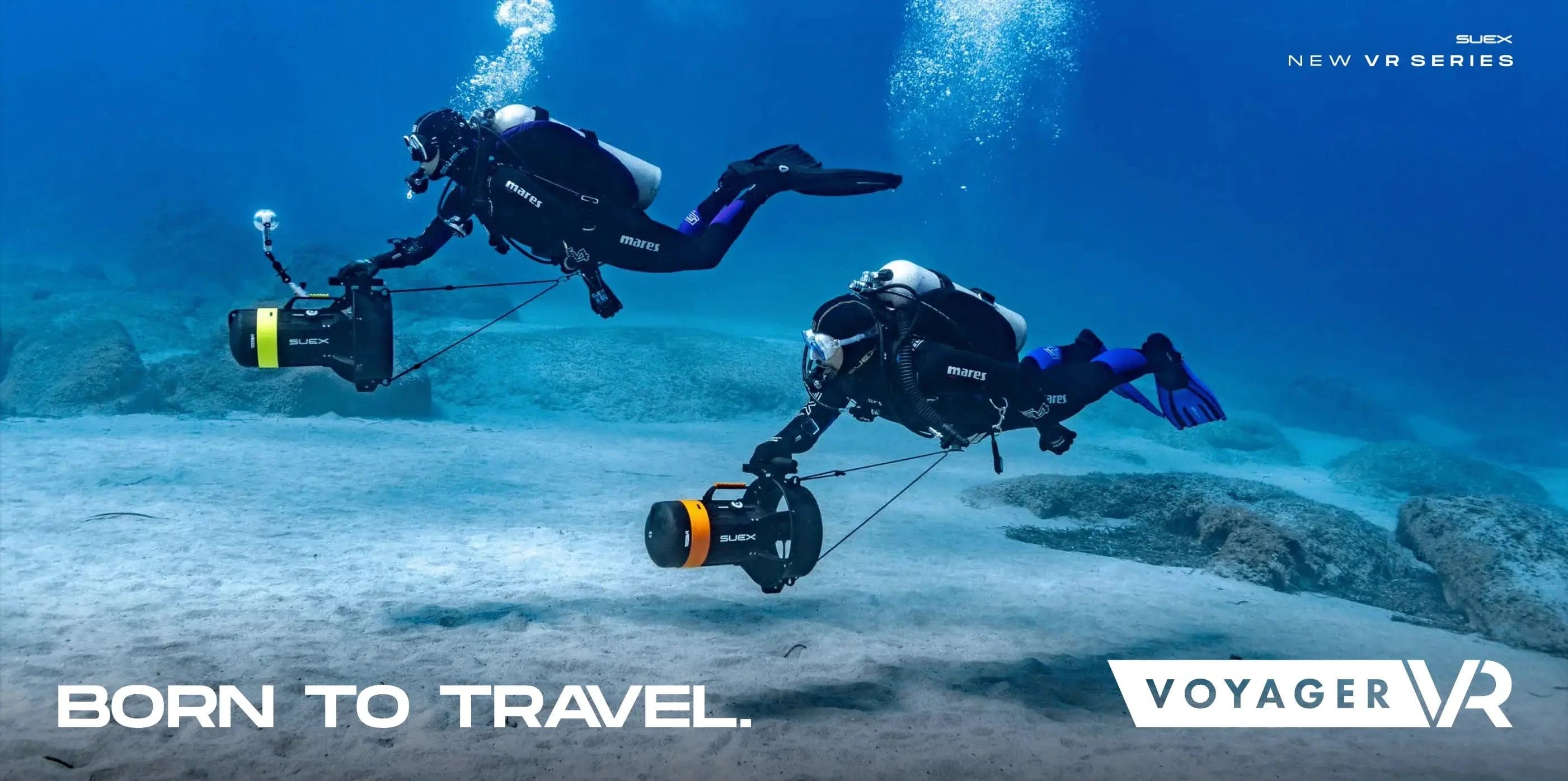 Scuba divers underwater, born to travel with Voyager VR.